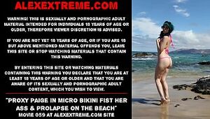 Proxy Paige in micro bikini fist her ass & mini-rosebud on the beach